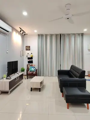 a living room with a couch and a tv at \u73ed\u53f0\u6c11\u5bbfNo 29 in Pantai Remis