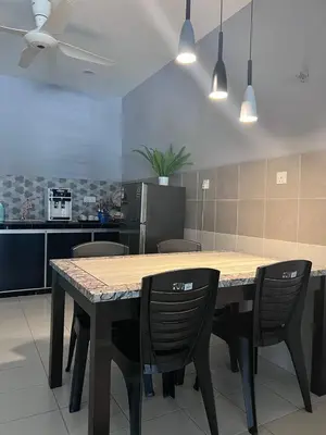 a kitchen with a wooden table and chairs in a room at \u73ed\u53f0\u6c11\u5bbfNo 29 in Pantai Remis