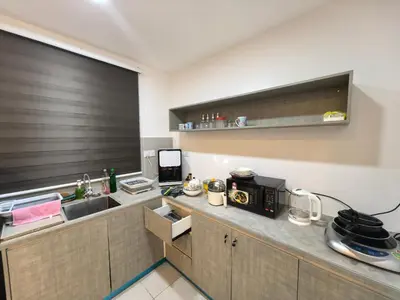 a kitchen with a counter with a sink and a microwave at Sky Suite Meritus Residence in Perai in Perai