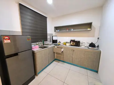 a small kitchen with a sink and a refrigerator at Sky Suite Meritus Residence in Perai in Perai