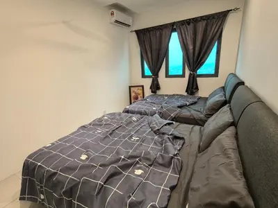 a bedroom with two beds and two windows at Sky Suite Meritus Residence in Perai in Perai