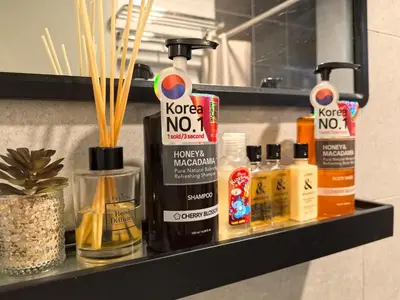 a shelf with bottles of hair products on it at Sky Suite Meritus Residence in Perai in Perai