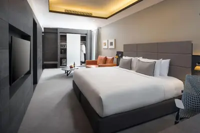 a hotel room with a large bed and a television at G Hotel Kelawai in George Town