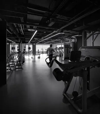 a gym with a man running on a treadmill at G Hotel Kelawai in George Town