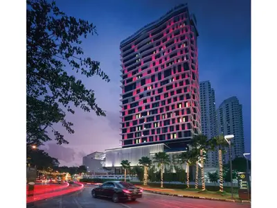 a tall red building with a car in front of it at G Hotel Kelawai in George Town