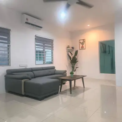 a living room with a couch and a table at Taiping Holiday Home 2 in Taiping