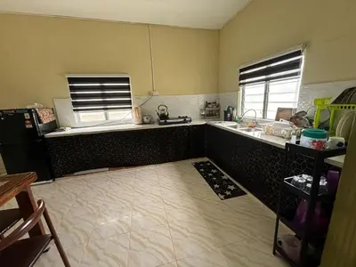 a kitchen with a sink and a counter top at Homestay Abah At in Baling