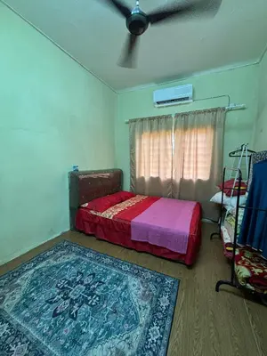 a bedroom with a bed and a rug at Homestay Abah At in Baling