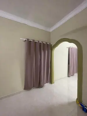 an empty room with a curtain and an archway at Homestay Abah At in Baling