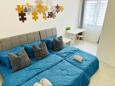 a bed with blue sheets and pillows in a room at BM\u5927\u5c71\u811a Double Storey Terrace Autocity Alma Aeon Jusco Nearby in Bukit Mertajam
