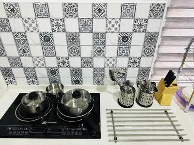 a kitchen with two pots and pans on a stove at BM\u5927\u5c71\u811a Double Storey Terrace Autocity Alma Aeon Jusco Nearby in Bukit Mertajam