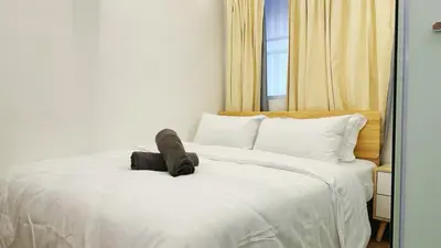 a large white bed with a stuffed animal on it at Noordin ClanJetties Komtar Heritage Studio - W in George Town