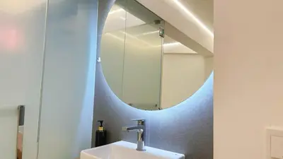 a bathroom with a sink and a mirror at Noordin ClanJetties Komtar Heritage Studio - W in George Town