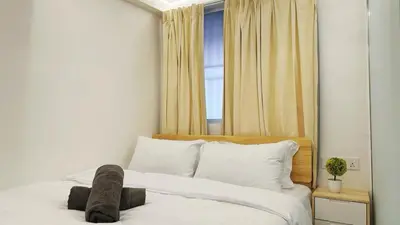 a bedroom with a bed with white sheets and a window at Noordin ClanJetties Komtar Heritage Studio - W in George Town