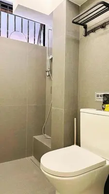 a bathroom with a white toilet and a shower at Noordin ClanJetties Komtar Heritage Studio - W in George Town