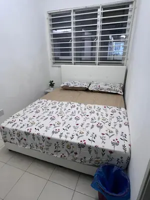 two beds in a room with a window at Ayaan Cozy Homestay Cameron Highland in Tanah Rata
