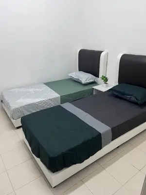 two beds sitting next to each other in a room at Ayaan Cozy Homestay Cameron Highland in Tanah Rata