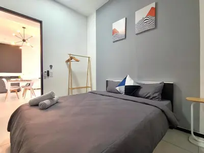 a bedroom with a large bed and a table at 2 Rooms Apartment, 4 to 5 pax at Urban Suites by SuperStay in Jelutong
