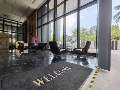 a lobby with chairs and a welcome mat on the floor at 2 Rooms Apartment, 4 to 5 pax at Urban Suites by SuperStay in Jelutong