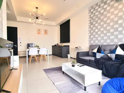 a living room with a couch and a table at 2 Rooms Apartment, 4 to 5 pax at Urban Suites by SuperStay in Jelutong