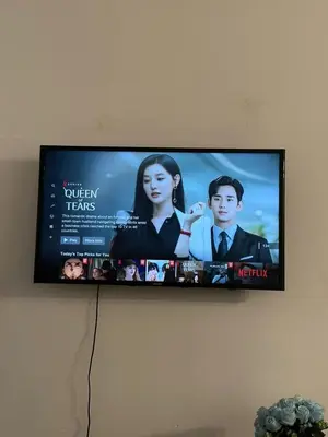 a flat screen tv hanging on a wall at AYAAN FAMILY HOMESTAY FREE WiFi in Tanah Rata