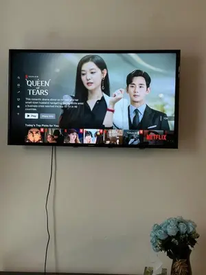 a flat screen tv hanging on a wall at AYAAN FAMILY HOMESTAY FREE WiFi in Tanah Rata
