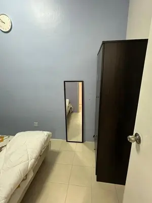 a bedroom with a mirror and a bed and a door at AYAAN FAMILY HOMESTAY FREE WiFi in Tanah Rata