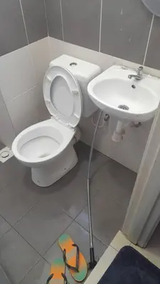 a bathroom with a toilet and a sink at AYAAN FAMILY HOMESTAY FREE WiFi in Tanah Rata