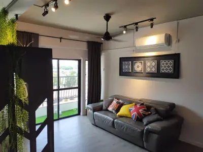 a living room with a leather couch and a balcony at Cozy 2-Bedroom Apartment in Air Itam, Perfect for Family & Friends Getaway in Ayer Itam