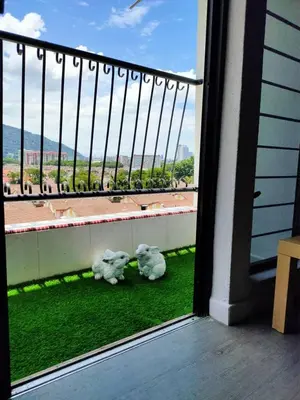 a balcony with two stuffed animals sitting on the grass at Cozy 2-Bedroom Apartment in Air Itam, Perfect for Family & Friends Getaway in Ayer Itam