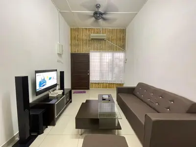 a living room with a couch and a tv at 3 rooms Town Homestay 1 mins to Town in Teluk Intan