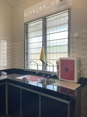 a kitchen with a sink and a pink appliance at 3 rooms Town Homestay 1 mins to Town in Teluk Intan