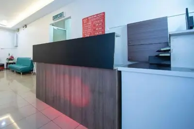 an office with a reception desk in a room at The Inn Hotel in Teluk Intan