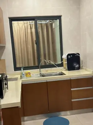 a kitchen counter with a sink and a window at Nova \u5bb6\u5ead\u623f in Brinchang
