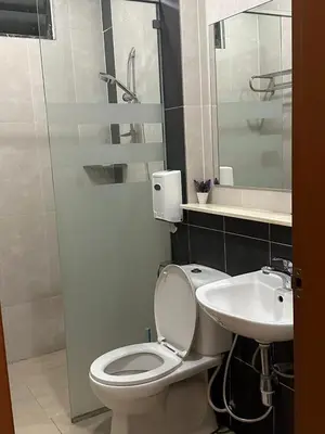 a bathroom with a toilet and a sink at Nova \u5bb6\u5ead\u623f in Brinchang