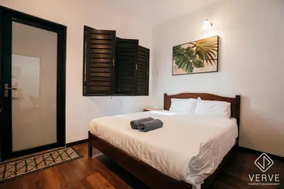 a bedroom with a bed with a suitcase on it at Ipoh Cozy 27 Pool Villa 6B5B 30 pax by Verve in Ipoh