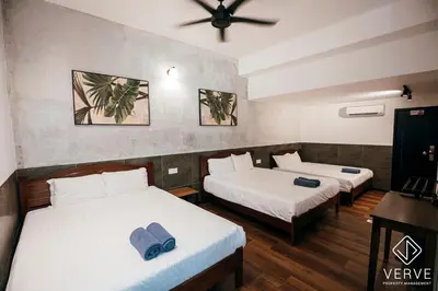 a room with two beds and a ceiling fan at Ipoh Cozy 27 Pool Villa 6B5B 30 pax by Verve in Ipoh