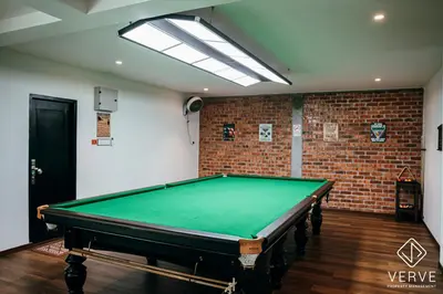 a pool table in a room with a brick wall at Ipoh Cozy 27 Pool Villa 6B5B 30 pax by Verve in Ipoh