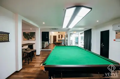 a pool table in the middle of a room at Ipoh Cozy 27 Pool Villa 6B5B 30 pax by Verve in Ipoh