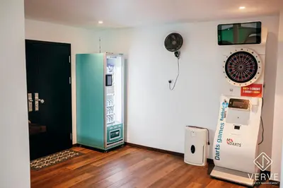 a room with a video game machine next to a wall at Ipoh Cozy 27 Pool Villa 6B5B 30 pax by Verve in Ipoh
