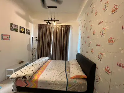 a bedroom with a bed in a room with a wall at Golden Hills Apartment Pasar Malam Night Market Cameron Highlands in Cameron Highlands