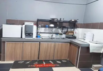 a kitchen with a sink and a counter top at Hotel Iskandar Perak in Seri Iskandar