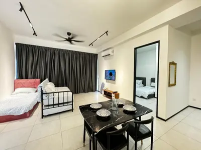 a living room with a bed and a dining table at b29 Condo In Georgetown Familystay 3BR-10PAX in Jelutong