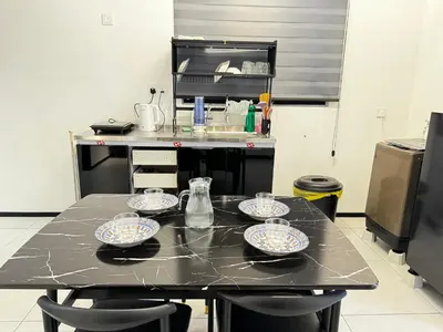 a kitchen with a table with four dishes on it at b29 Condo In Georgetown Familystay 3BR-10PAX in Jelutong