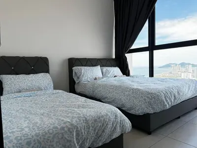 two beds in a bedroom with a large window at b29 Condo In Georgetown Familystay 3BR-10PAX in Jelutong