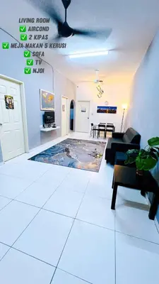 a living room with a couch and a table at SS MANJUNG HomeSTAY in Seri Manjung