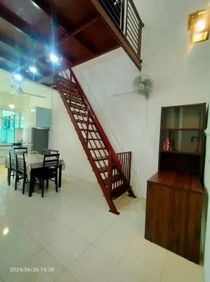 a dining room with a table and chairs and a staircase at Pa&Ma HomeStay Kulim II 3R2B fully aircond wifi netflix in Kulim