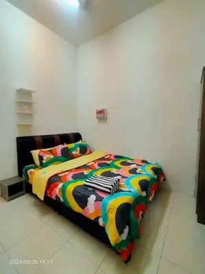 a bed with a colorful comforter in a room at Pa&Ma HomeStay Kulim II 3R2B fully aircond wifi netflix in Kulim