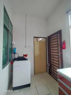 a kitchen with a refrigerator and a wooden door at Pa&Ma HomeStay Kulim II 3R2B fully aircond wifi netflix in Kulim