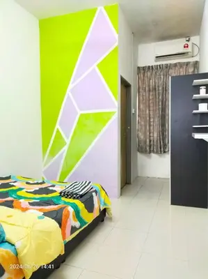 a bedroom with a bed and a green wall at Pa&Ma HomeStay Kulim II 3R2B fully aircond wifi netflix in Kulim